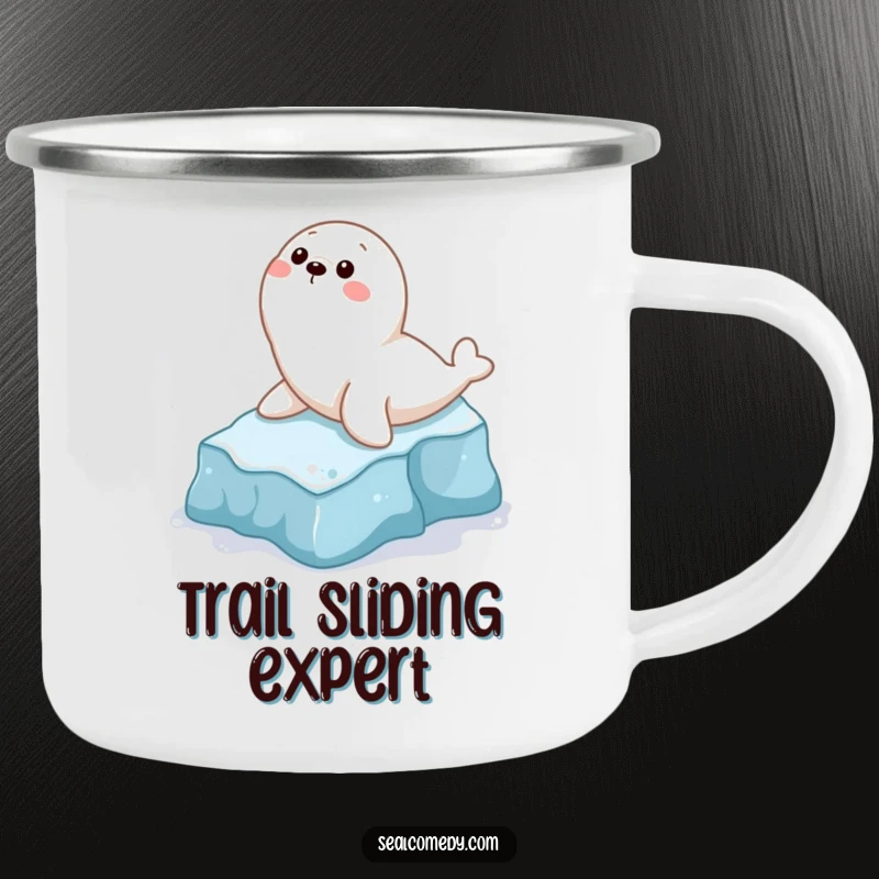 Funny camping mug showing a playful seal character gleefully sliding down a small icy slope, ideal for outdoor fun.