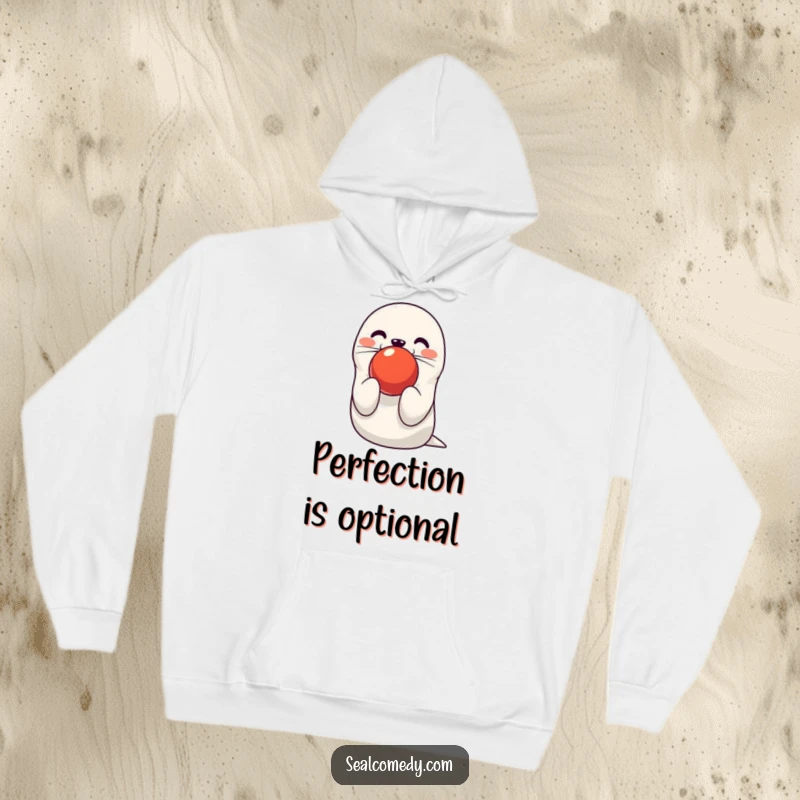 Funny seal hoodie showing a cute character balancing a red ball on its nose, providing warmth and circus fun. Great funny gift.