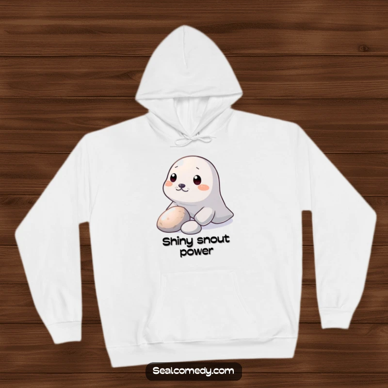Funny Hoodie: A seal nudges a shiny pebble with its snout, embodying curious and humorous exploration.