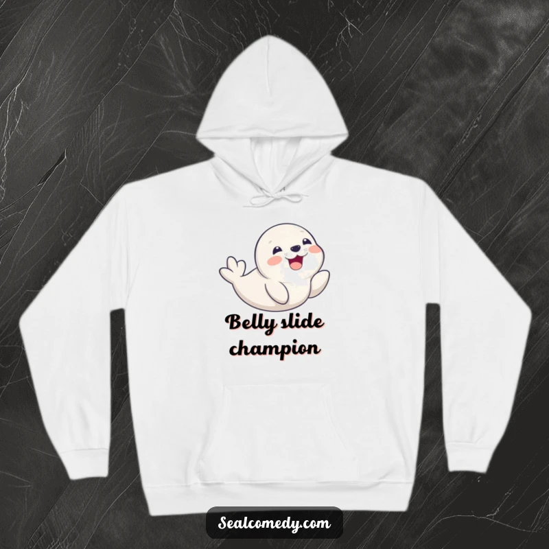 Funny seal pup captured mid-belly slide with a huge smile, featured on a warm and cozy hoodie.
