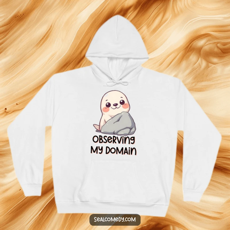 Funny hoodie design of a seal curiously peeking from behind a large rock, adding a touch of playful suspense.
