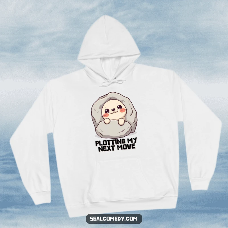Funny mischievous seal hoodie, depicting a seal peeking from behind a rock, embodying playful secrecy and warmth.