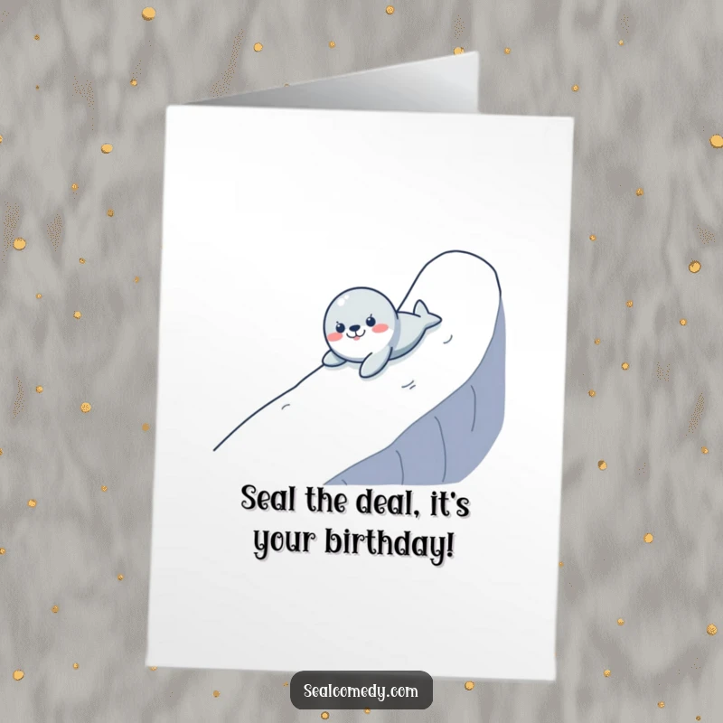 Funny free printable birthday card: Cute seal comically sliding down a slope, spreading birthday cheer with a grin.