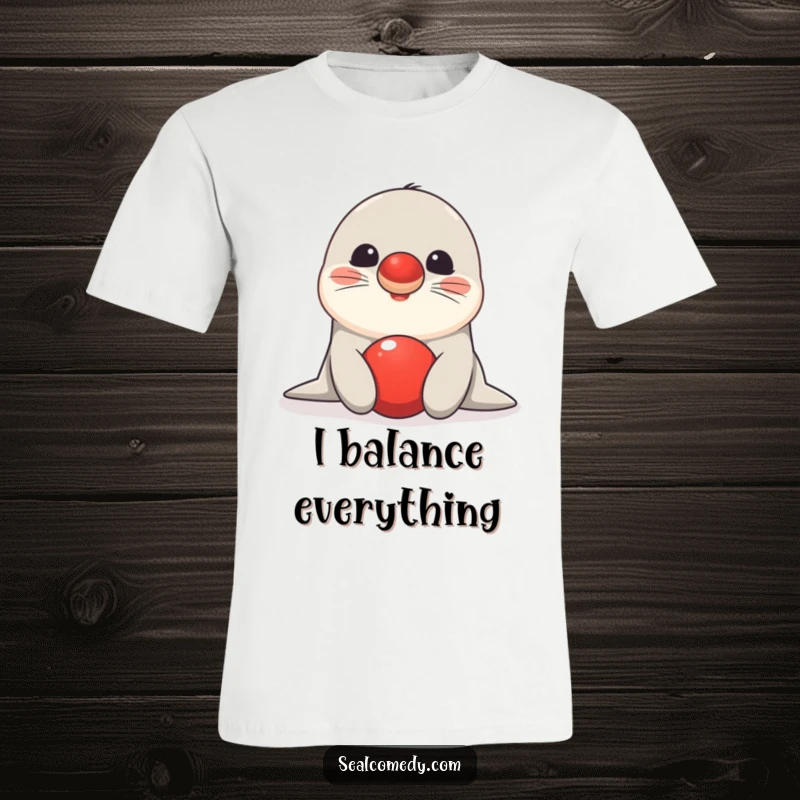 Funny seal t-shirt depicting a happy marine mammal perfectly balancing a vibrant red ball on its nose, showcasing remarkable skill.