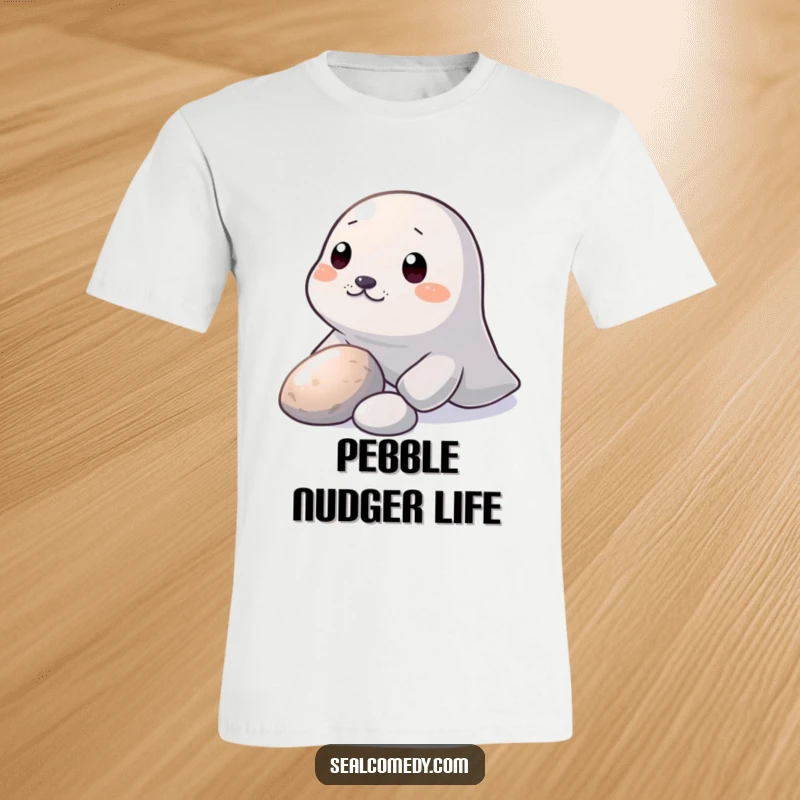 Funny T-Shirt: A seal nudges a shiny pebble with its snout, depicting playful curiosity and humor.