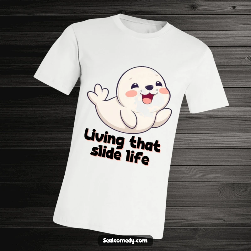 Funny seal pup in mid-belly slide, sporting a massive delighted smile, printed on a soft graphic tee for maximum fun.