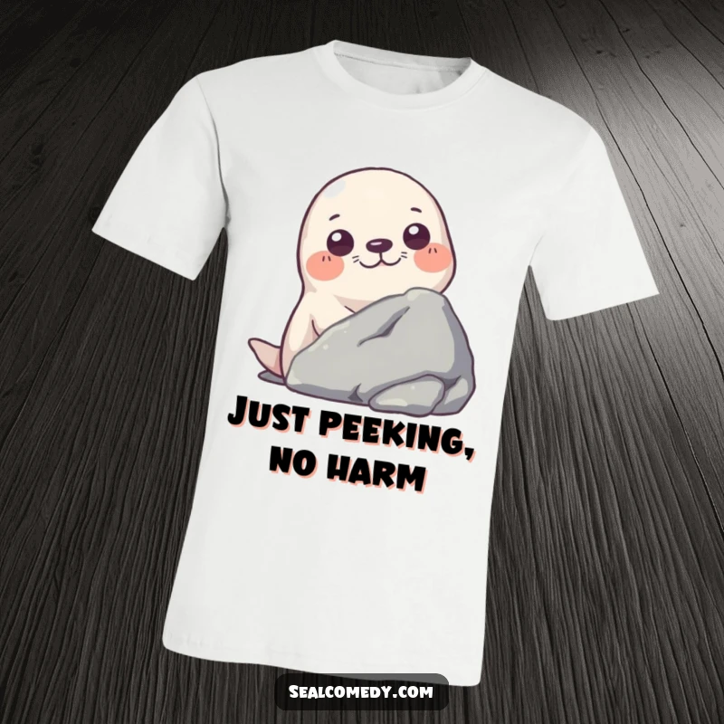 Funny t-shirt graphic of a seal with wide, curious eyes peeking out from behind a textured rock.